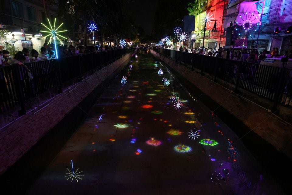 Lights are projected on a canal during a Loy Krathong celebration to encourage people to use digital krathongs instead of actual ones, to reduce waste, in Bangkok, Thailand, November 27, 2023. REUTERS/Thomas Suen/ File photo